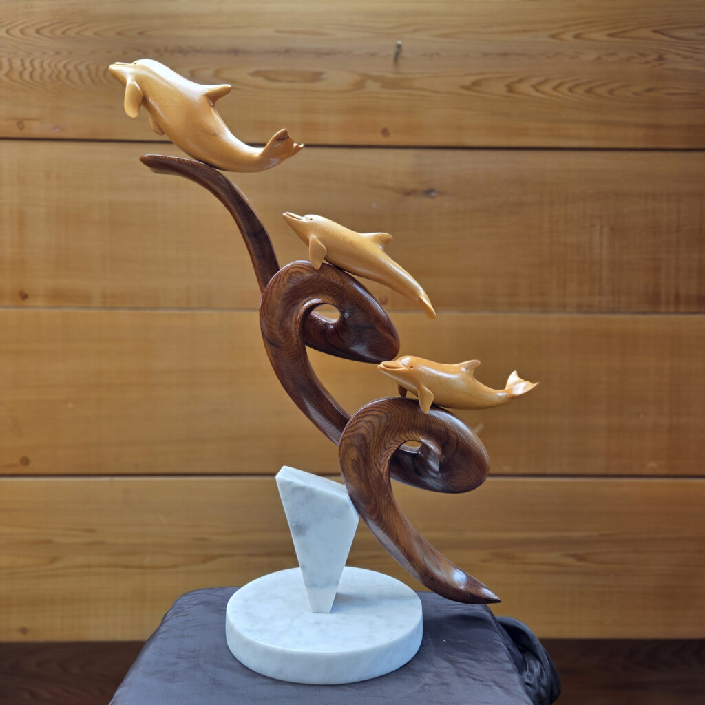 Dolphin Wood Sculptures in the Gallery, from Vancouver Island Yellow Cedar with Red Cedar Marble Base