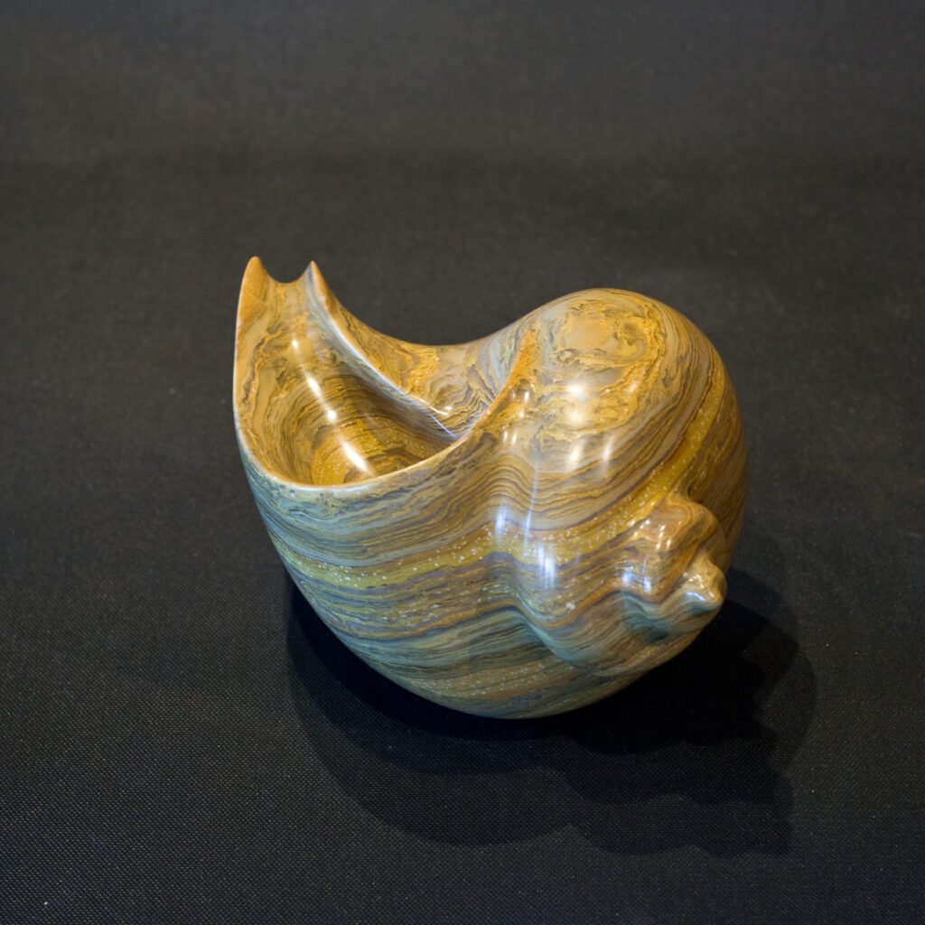 Marble stone sculpture of a shell a touchstone piece. Approximately 15 cm tall.